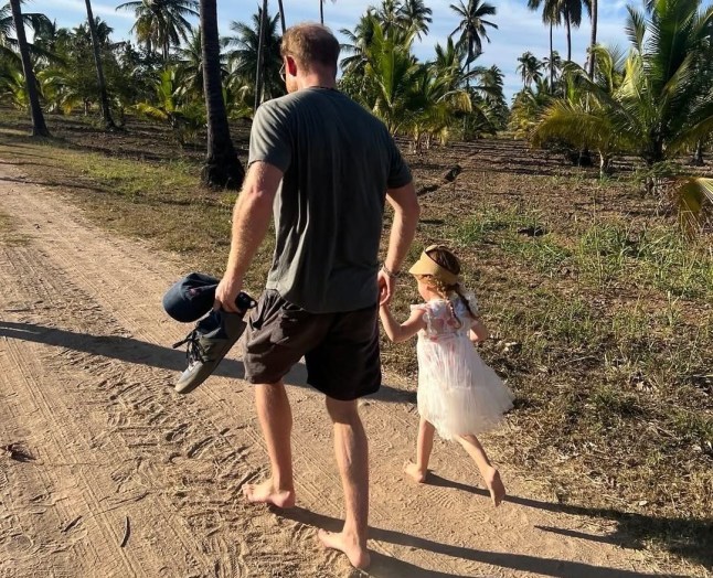 Prince Harry with Lilibet outside.