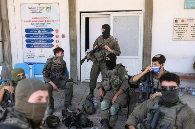 Israeli soldiers sit at the entrance to the European Hospital in Khan Younis at the Gaza Strip, where they found a tunnel underneath it, amid the ongoing ground operation of the Israeli army against Palestinian Islamist group Hamas, June 8, 2025. REUTERS/Ronen Zvulun EDITOR'S NOTE: REUTERS PHOTOGRAPHS WERE REVIEWED BY THE IDF AS PART OF THE CONDITIONS OF THE EMBED. NO PHOTOS WERE REMOVED.