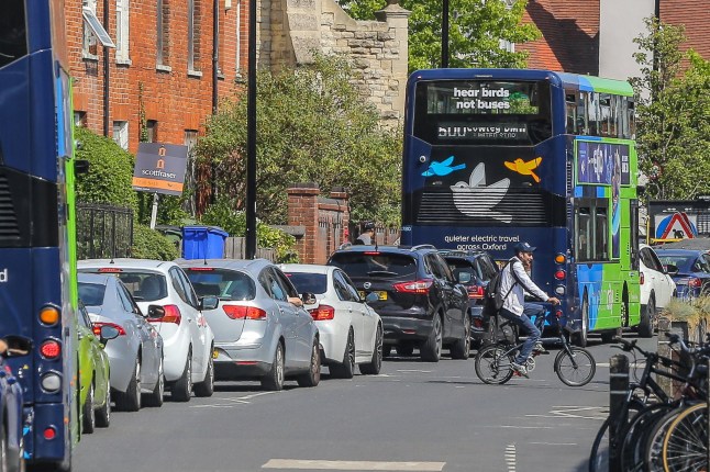 Vehicles queuing up and cyclist on the road in Oxford, where the council is planning a new congestion charge.