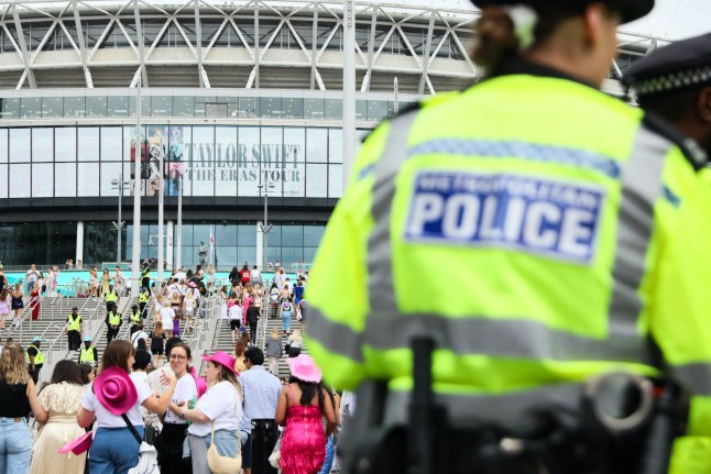 LONDON, ENGLAND - AUGUST 15: (EDITORIAL USE ONLY) A police officer stands outside Wembley Stadium ahead of Taylor Swift's performance on August 15, 2024 in London, England. Following the cancellation of her Vienna gigs last week due to a foiled terror plot, the singer's first performance will feature heightened security measures. New rules include prohibiting 'Swifties' from gathering outside entrances, banning camping, and restricting items such as large bags, non-medical face coverings, chains, and hard plastics. (Photo by Alishia Abodunde/Getty Images)