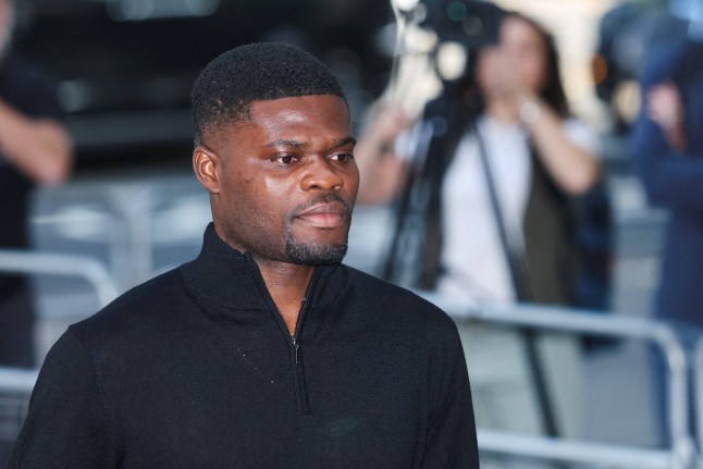 Former Arsenal player Thomas Partey, who has been charged with five counts of rape and one count of sexual assault, walks outside Westminster Magistrates' Court, in London, Britain, August 5, 2025. REUTERS/Toby Melville